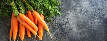 Top view of a bouquet of fresh carrots on a gourmet background with copy spaceの素材