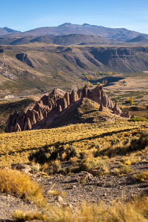 Los Bolillos, unique rock formations under a clear sky with mountains in the distance in autumn season. Neuquen province, Argentinaの写真素材