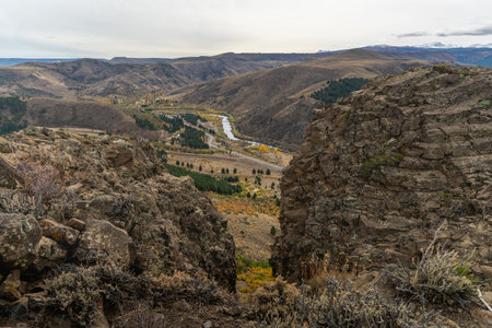 Scenic view of Alumine river from a rocky cliff shows a valley on a cloudy day in autumn season. Neuquen, Patagonia, Argentinaの写真素材