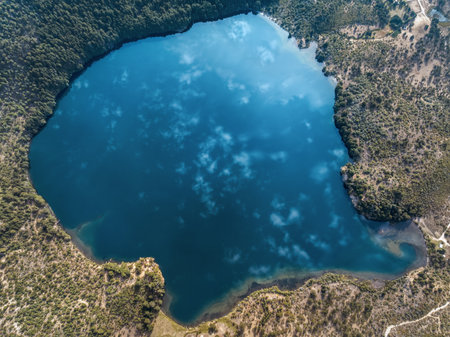Aerial top view of Laguna Matetuwe reflecting clouds on water. Villa Pehuenia, Neuquen, Argentinaの写真素材