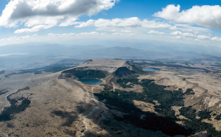 Batea Mahuida and small lagoon aerial panoramic view under cloudy sky. Neuquen province, Argentinaの写真素材