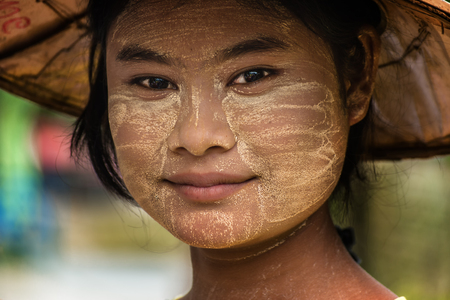 portrait of a Burmese girl. Women in Myanmar Thanakha use the powder to protect the skin from the sun's rays.のeditorial素材