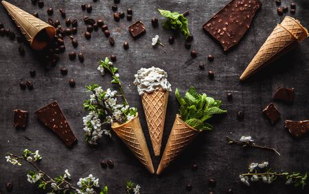 Ice cream, chocolate and coffee. Spring flowers and greens