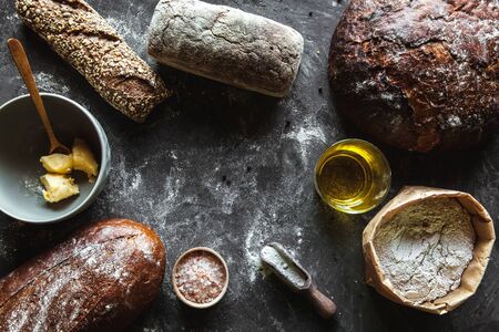 Bread on a black background. Homemade pastries with ingredients.