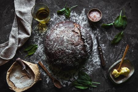 Bread on a black background. Homemade pastries with ingredients.