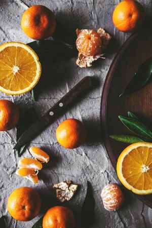 Citrus on table: mandarin, tangerine with a knife. Fresh organic juicy fruits.の写真素材