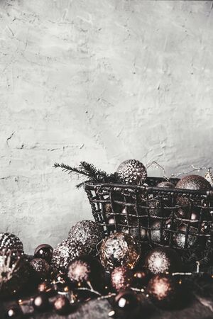 vintage christmas, new Year toys and decoration in basket on brown wooden table, copy spaceの写真素材