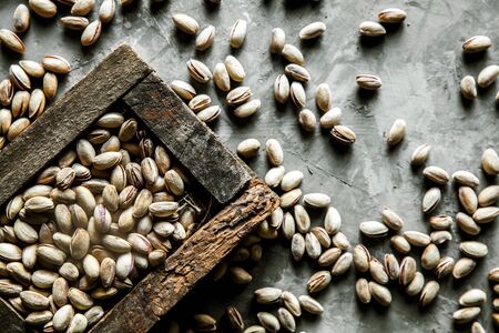 Pistachios nuts in wooden box. Top viewの写真素材