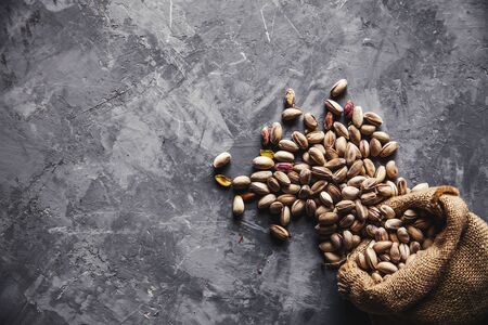 Roasted pistachios on natural wooden table backgroundの写真素材