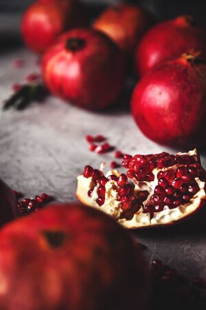 Pomegranate fruit. Ripe and juicy pomegranate on rustic grey background with copy space for your text.の写真素材