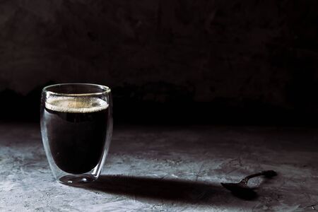 Espresso coffee in shot glass sepia tone with soft shutterの写真素材