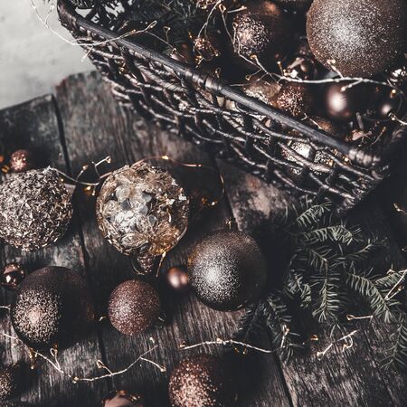 vintage christmas, new Year toys and decoration in basket on brown wooden table, copy spaceの写真素材
