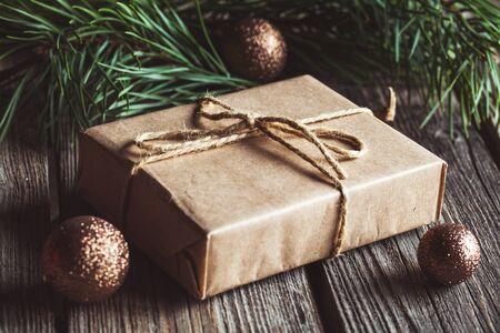 Christmas and New Year background with branch, decorations and presents wrapped in craft papers.の写真素材