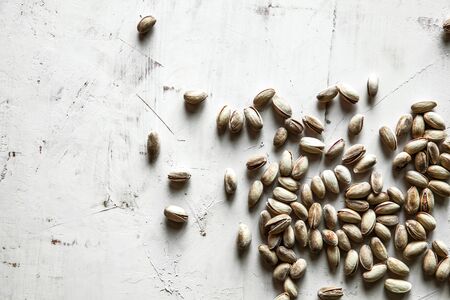 Big set of salted pistachios on the table. Pistachios nuts