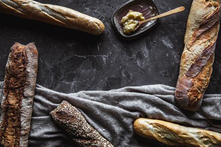Bread on a black background. Homemade pastries with ingredients.の写真素材
