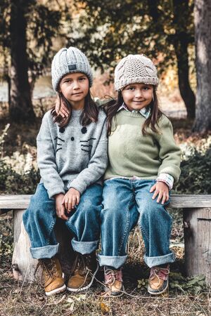 Two little child girls hugging each other with loveの写真素材