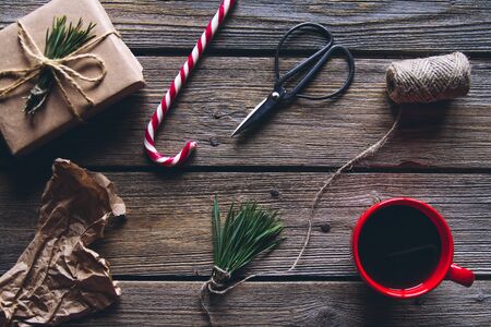 Hand made craft gifts of paper with ribbon at Christmas holiday and small presents. On wooden background, Top view. Making New Year home decorationの写真素材