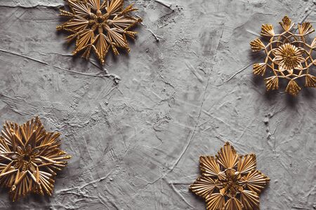 New Year's straw toys, on a gray concrete background. Christmas card