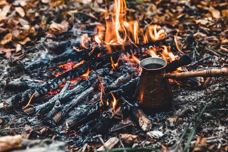Making coffee at the stake. Make coffee or tea on the fire of nature. Burned fire. A place for fire. Ashes and coal.の写真素材
