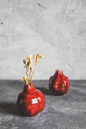Pomegranate vase on a gray background. Vintage styleの写真素材