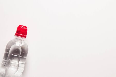 Plastic bottle of water with red cap. Transparent bottle of noncarbonated water on white background, front view.の写真素材
