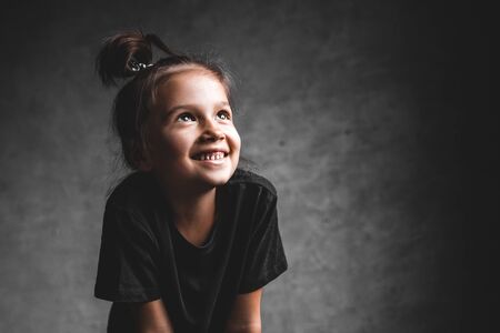 Little girl on a gray background. Portrait in beautiful colorsの写真素材