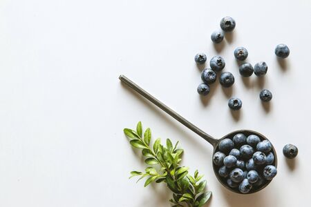 Blueberries in a spoons isolated on a white background. Healthy food, healthの写真素材