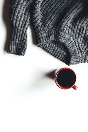 Autumn composition. Cup of coffee, sweater on white background. Autumnの写真素材