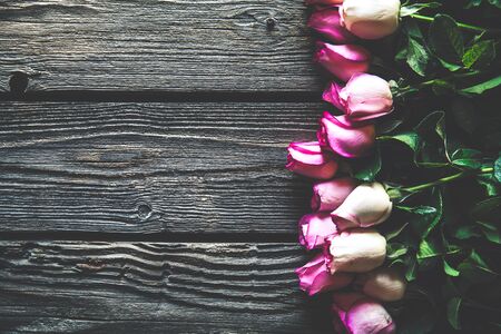 Pink roses bouquet over wooden table. Top view with copy space. flowersの写真素材
