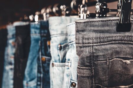 Rack with different jeans on grey backgroundの写真素材