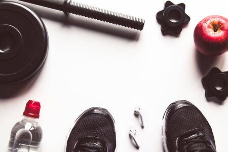 Fitness concept background with sneakers, water bottle. Top view with space for your text