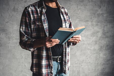 Student holding in hand a stack of old books. learning, success, knowledgeの写真素材