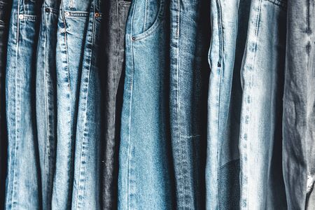 Rack with different jeans on grey backgroundの写真素材