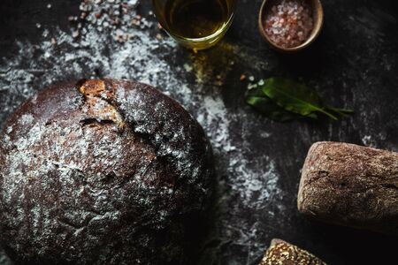 Bread on a black background with flour and oil. The bread is on the towel. homemade foodの写真素材