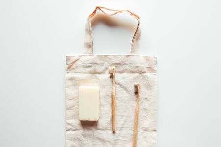 Natural brushes made of wood and soap on the background of concrete, bamboo toothbrushes and body brush, handmade soap with loofah, eco-friendly lifestyle concept and zero waste, copy spaceの写真素材