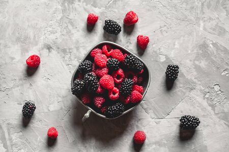 Fresh berries raspberries, blackberries on a gray art background. Healthy food, summer berries, slimming food.の写真素材