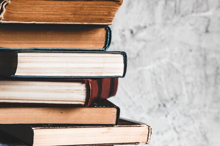 Education and reading concept, group of old colorful books on the white table on the gray backgroundの写真素材