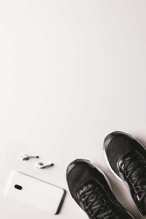 Mockup mobile cellphone with earphone and running shoes on white background. Healthy active lifestyles background concept. Daily workout and relax music lifestyles .の写真素材