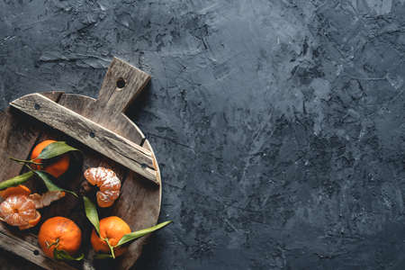 Fresh orange mandarin on wooden cutting board. eco vegetarian. PNOV2019の写真素材