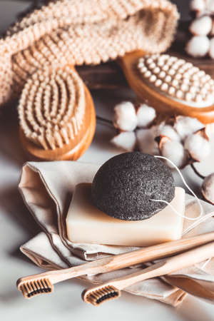 Natural brushes made of wood and soap on the background of concrete, bamboo toothbrushes PNOV2019の写真素材