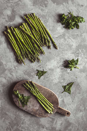 Asparagus on a cutting board. Healthy food, health on a concrete background.の写真素材