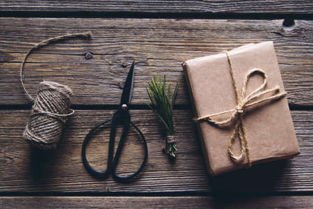Hand made craft gifts of paper with ribbon at Christmas holiday and presents. On wooden background