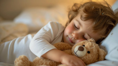 A young child sleeps peacefully, holding a teddy bear close, with a serene expression on her face, in a warm and comfortable bed setting.の素材