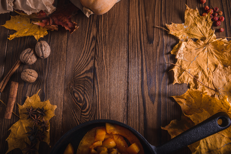 Pumpkin, walnuts, maple leaves - autumn composition from top. Free space for textの写真素材