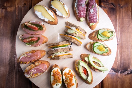 Bruschetta crostini set on a wooden tray. The concept of the Italian cuisine.の写真素材