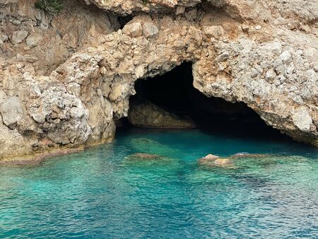 Picturesque entrance to the cave. Turquoise water near the grotto.の写真素材