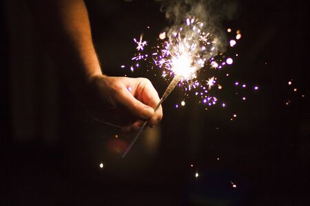 Bengal fire in the man's hand. sparks.の写真素材