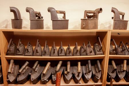 collection of cast iron irons. old irons with coal, old irons with smoke pipe.の写真素材