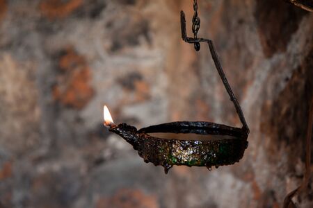 ancient lighted oil lamp. lighting in ancient people.の写真素材