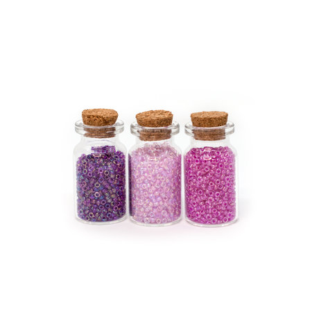 Three bottles full of beads isolated on white background. storage of beads.の写真素材